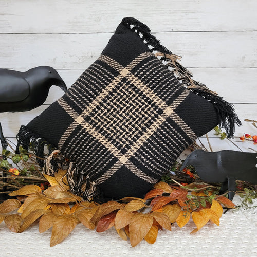 Black and tan woven tartan plaid hrow pillow in a fall vignette.