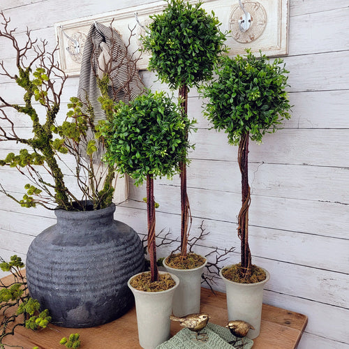 Set of three artificial boxwood topiary trees.