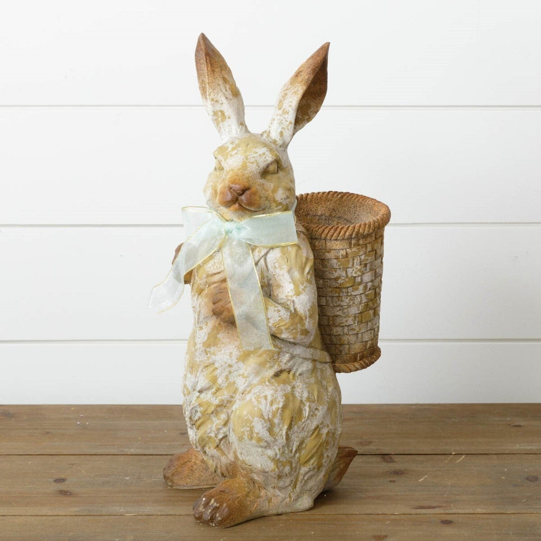 Weathered cottage bunny statue with a basket vase.