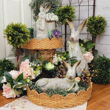 Load image into Gallery viewer, Cottage garden display with weathered rabbit statues.
