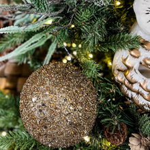 Load image into Gallery viewer, Encrsted neutral ornament in a Christmas tree.
