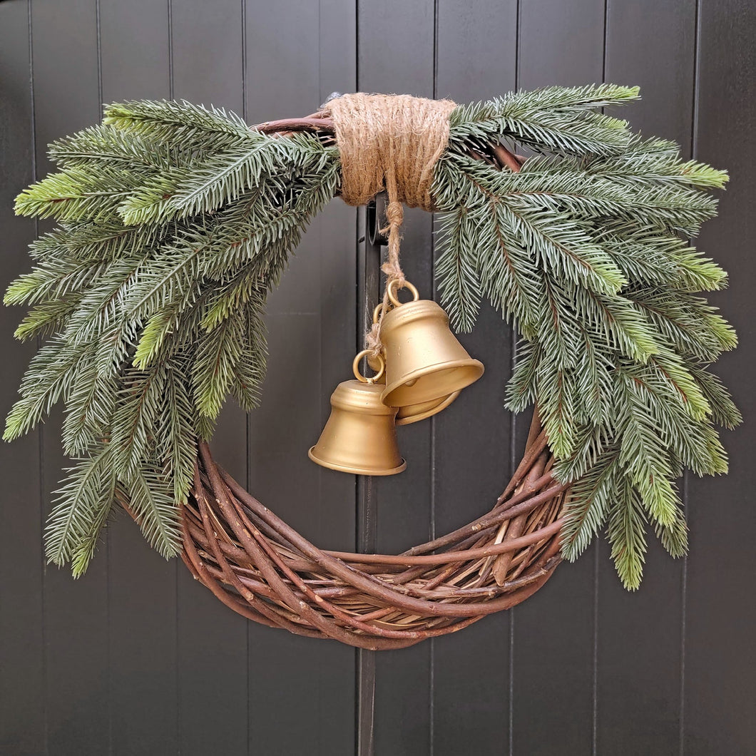 Pine swag natural willow wreath with brass bells.