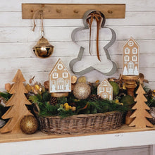 Load image into Gallery viewer, Golden jingle bell, metal gingerbread cookie cutter and houses holiday display.
