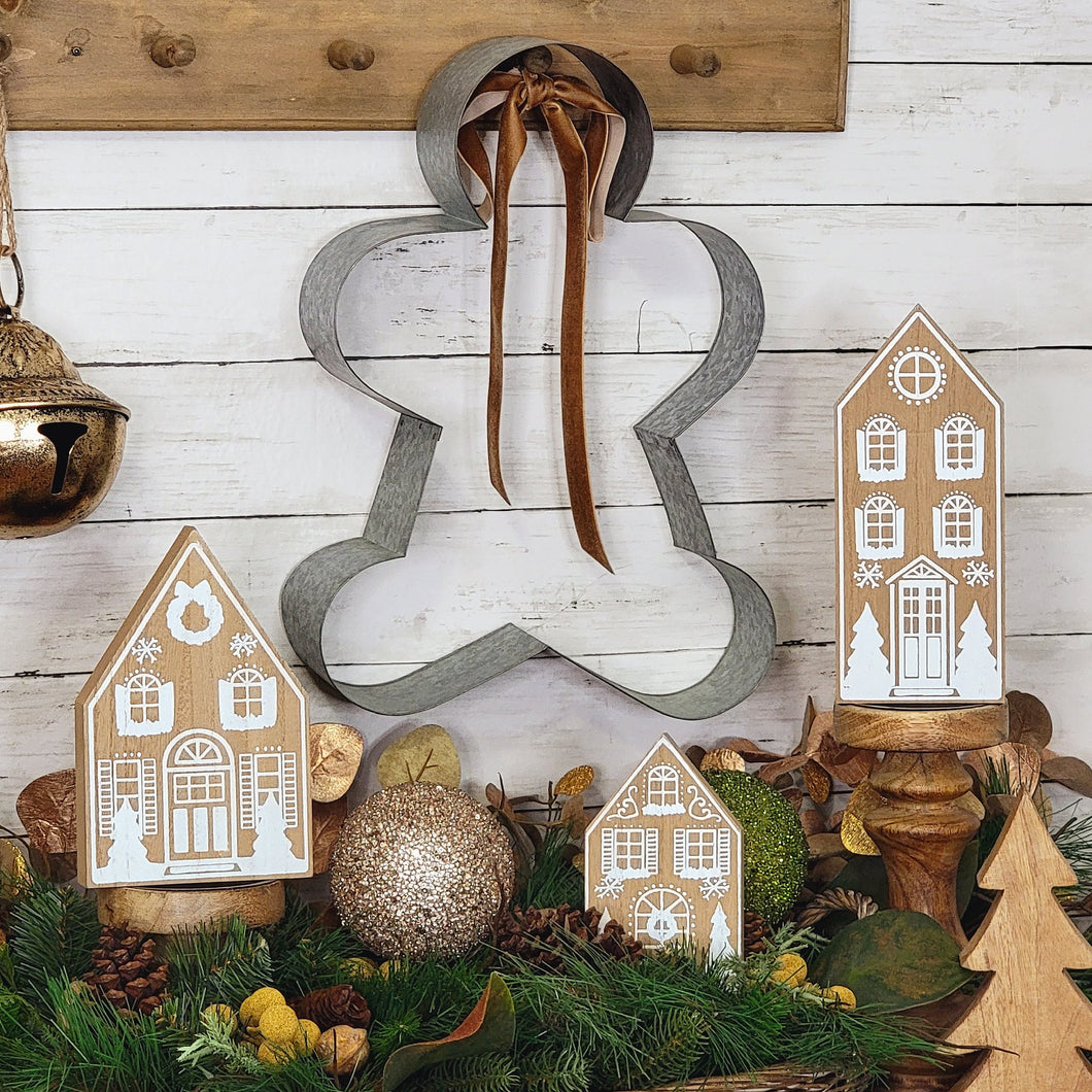 Large metal gingerbread man cookie cutter shaped wall sign.