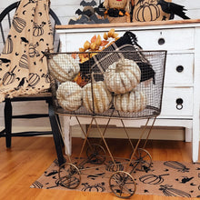 Load image into Gallery viewer, Farmhouse raven harvest fall doormat rug, vintage metal laundry basket filled with birch pumpkins.
