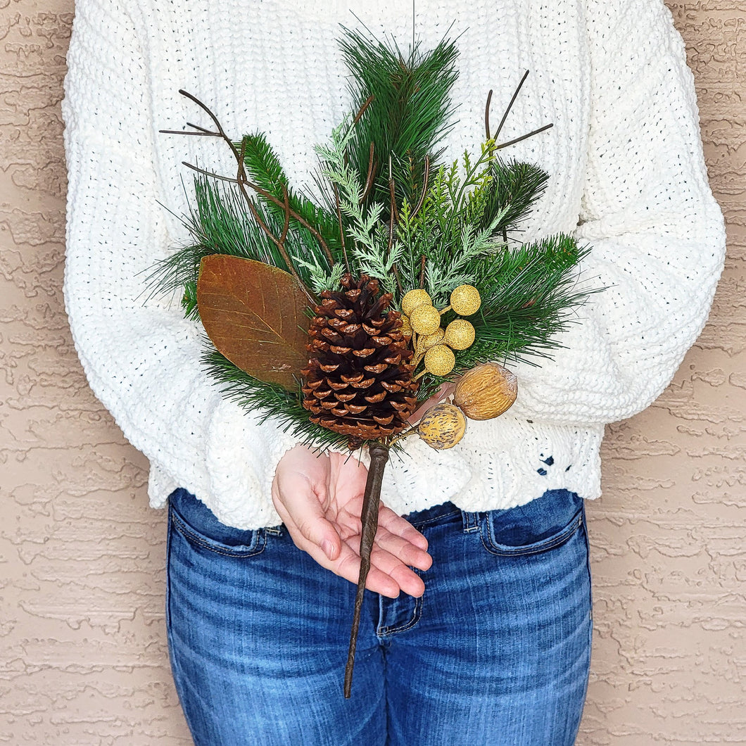 Artificial pine, cone, and nut evergreen floral pick.