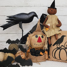Load image into Gallery viewer, Primitive fall decor vignette with a pumpkin with, wood bats, black crow or raven, and scarecrow sitter. 
