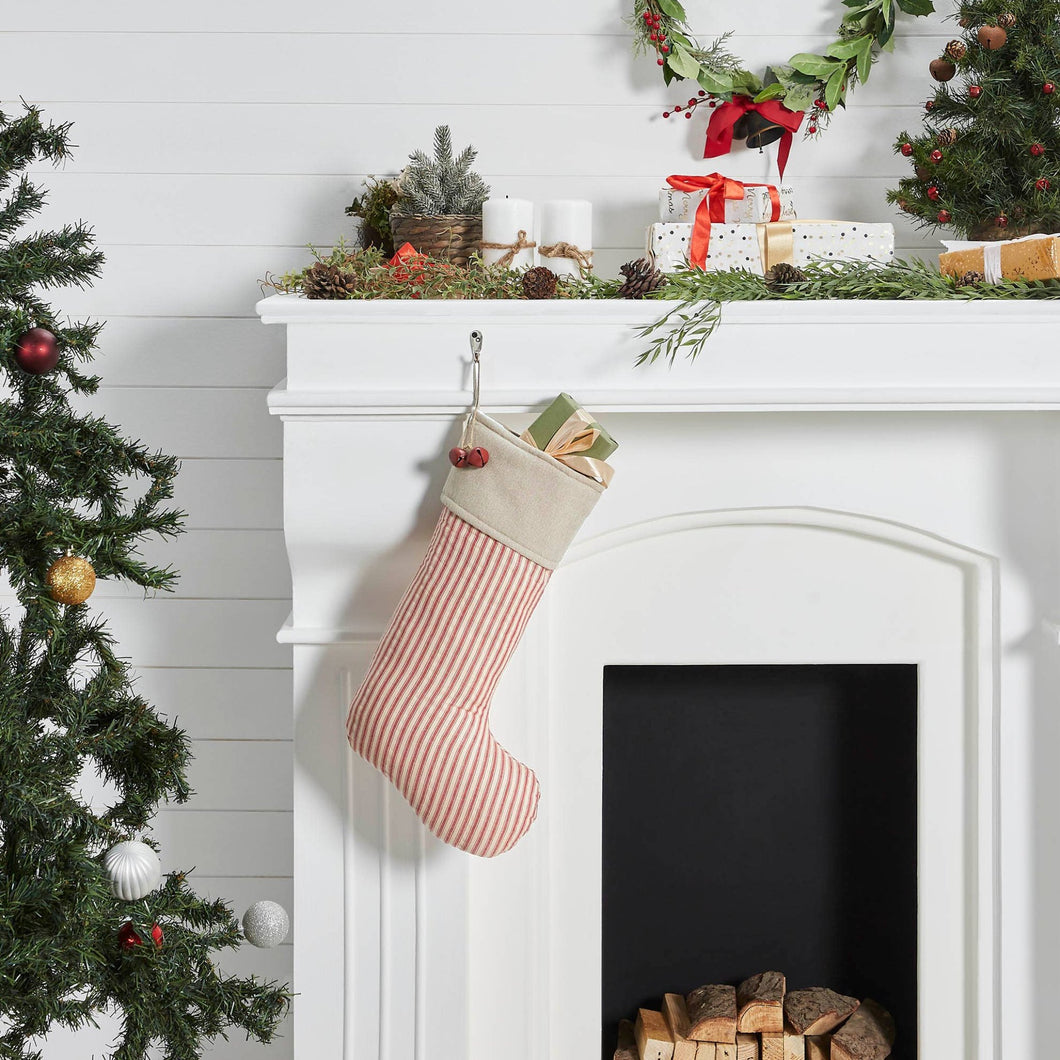 Vintage-Inspired Red Ticking Stripe Christmas Stocking hung on a white fireplace mantel.