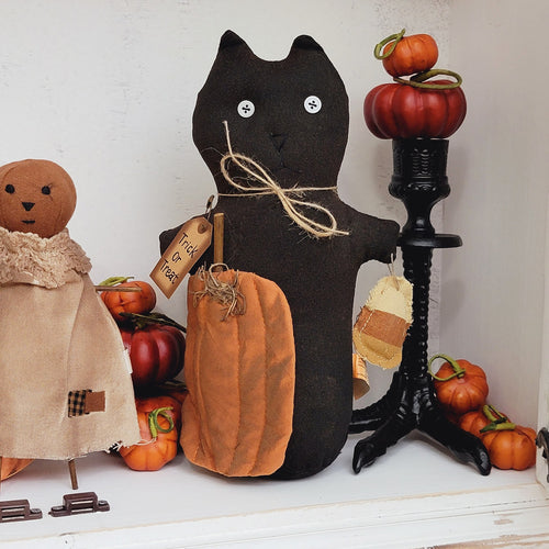 Primitive spooky trick or treat stuffed black cat doll shelf sitter with candy corn.