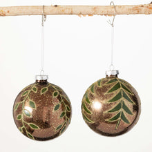 Load image into Gallery viewer, Shimmery winter leaves on a gold and brown glass bulb ornament.
