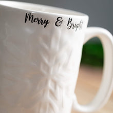 Load image into Gallery viewer, Merry &amp; Bright snowflake embossed mug.
