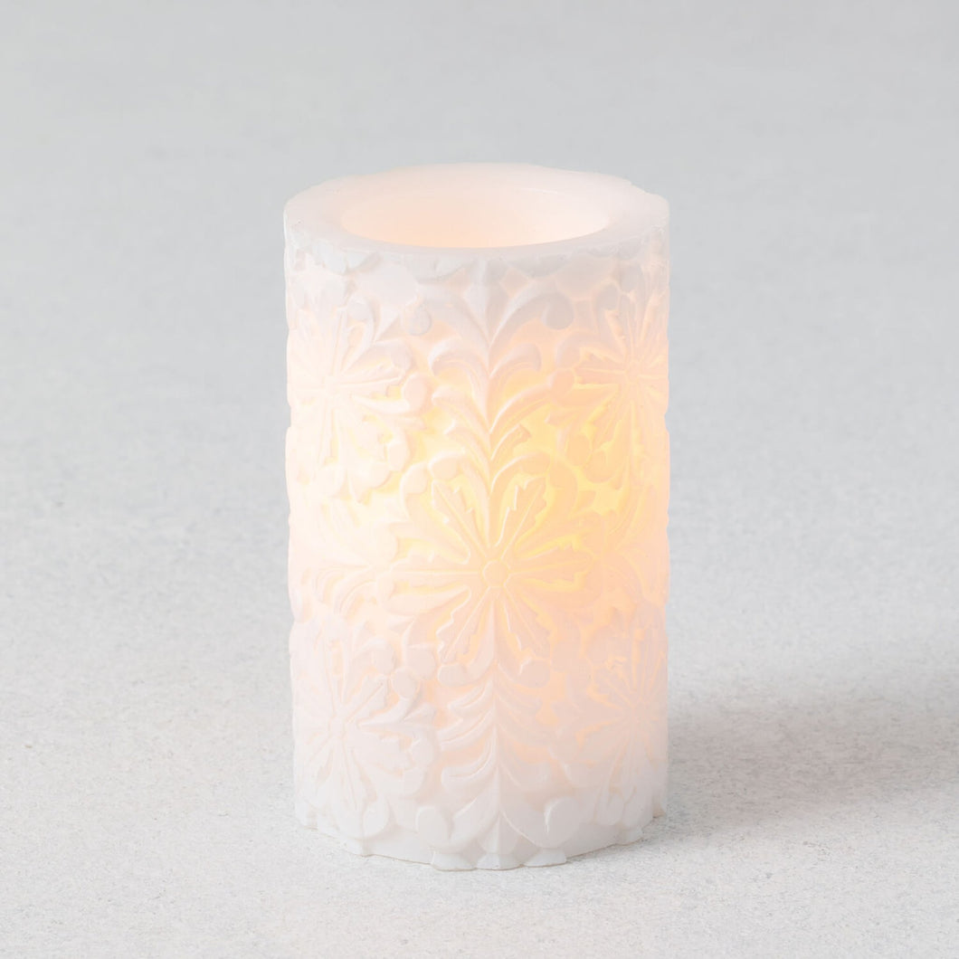 Snowflake carved wax flameless pillar candle.