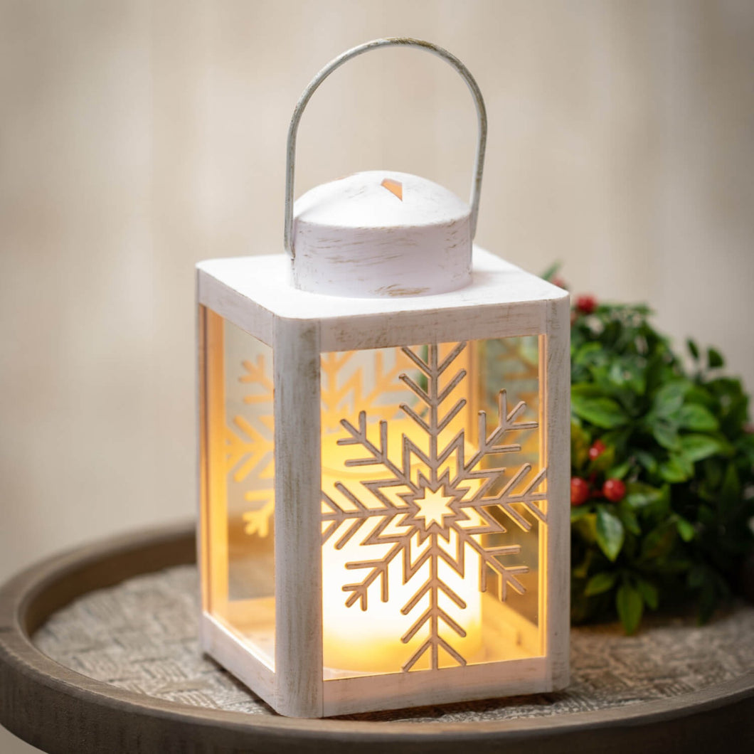 Distressed white snowflake LED flameless candle lantern.