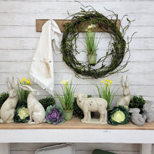 Load image into Gallery viewer, Spring side table display with a mossy twig wreath, faux daffodils, and cottage bunnies.
