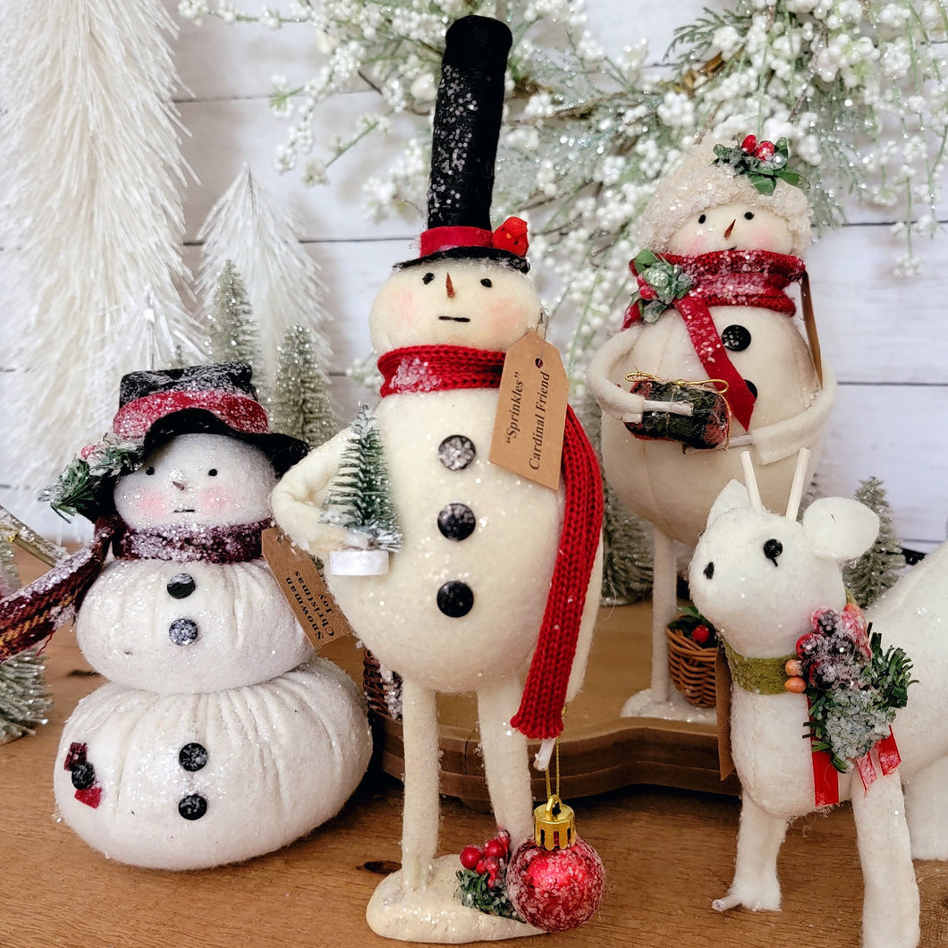 Sprinkles the primitive stuffed snowman, snowwoman,, and deer figurines.