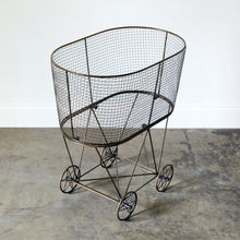 Load image into Gallery viewer, vintage inspired bronze metal rolling laundry basket.
