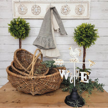 Load image into Gallery viewer, Rustic farmhouse side tablw with willow baskets, weathervasne, ticking stripe tea towels and boxwood topiaries.
