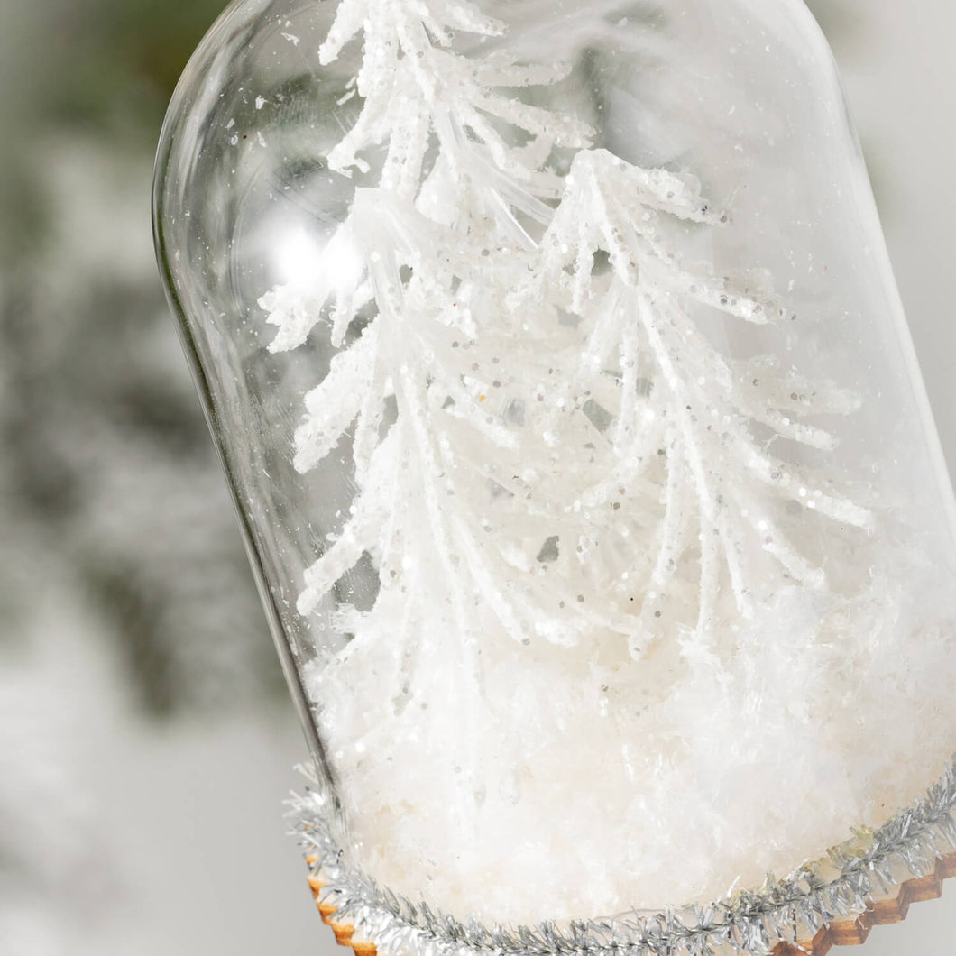 Winter snow trees in a glass cloche ornament.