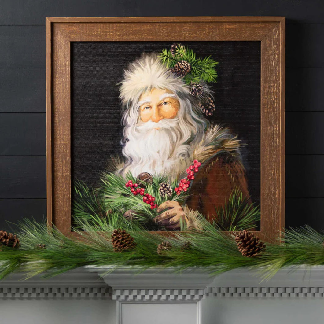 Woodland St. Nick Santa framed portrait displayed on a mantel with long pine garland.