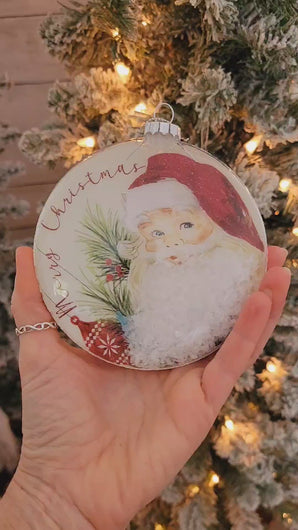 Unique vintage-inspired round disc glass Santa ornaments filled with snow.