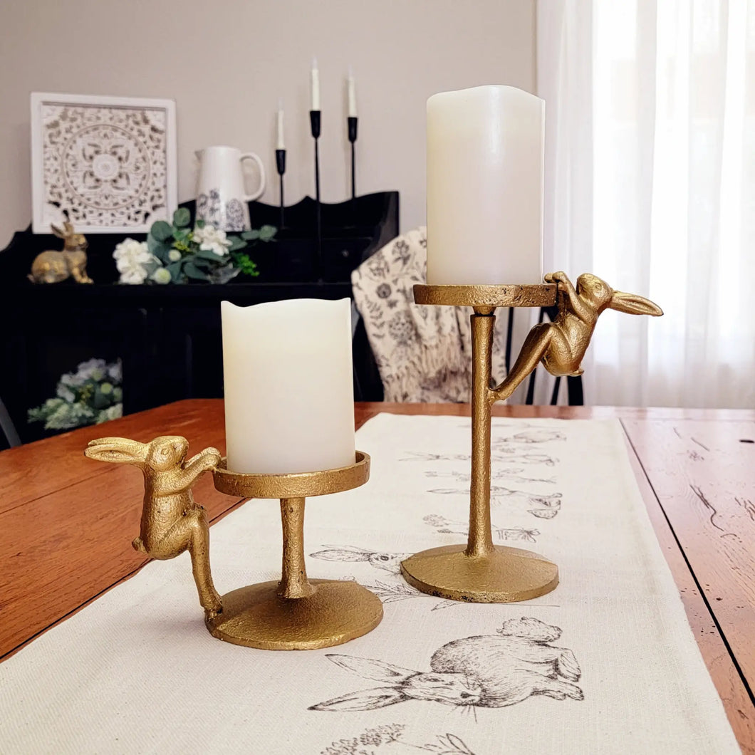 Gold Bunny Pillar Candle Holders with Flameless LED Real Wax Candles displayed on a linen style table runner