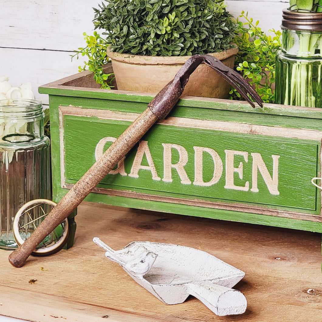 Vintage inspired hand rake and green garden decor planter box