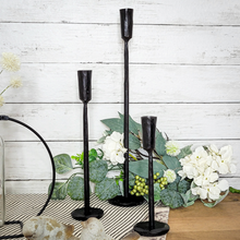 Load image into Gallery viewer, Hand Forged Black Iron Taper Candle Holders display with artificial white hydrangea and green foliage pick
