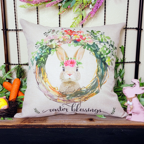 18 x 18 inch pillow cover with Whimsical cottage bunny wearing a rose flower garland surrounded by a spring floral wreath saying Easter Blessings