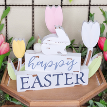 Load image into Gallery viewer, Chippy White Distressed Wood Block Happy Easter Stacked Sign with Bunny on top surrounded by Tabletop Tulips
