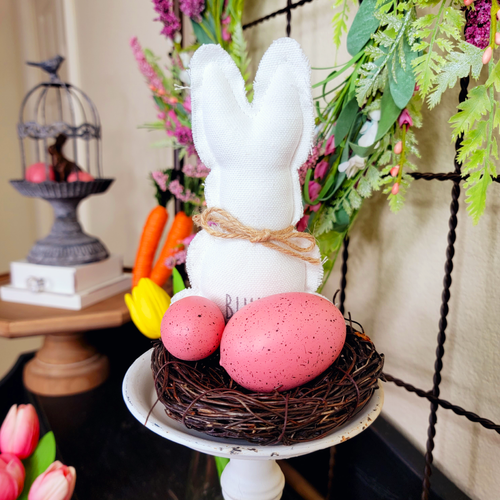 White Fabric Bunny with Pink Faux Easter Eggs in a Birds Nest