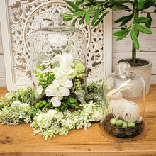 Load image into Gallery viewer, Large and small glass cloche set filled with white hydrangea and greenery. The small cloche is displayed with a birdnest and distressed painted bunny figurine.
