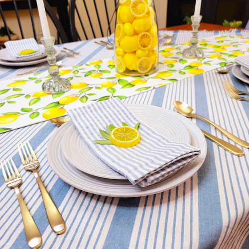 French country blue and white seersucker stripe napkin with a lemon theme table setting
