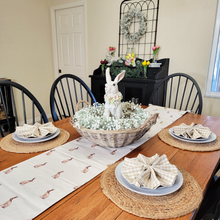 Load image into Gallery viewer, Easter Tablescape with a Rabbit Borwn and Tan Table Runner wicker basket centerpiece with baby&#39;s breath and a large cottage bunny rabbit statue Gingham napkins round jute placemats
