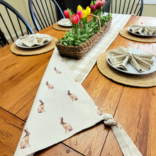Load image into Gallery viewer, Reversible Linen and Tan Plaid Table Runner with Cottage Bunnies Chipwood basket centerpiece with artificial sage greenery assorted spring tulips in glass milk bottles gingham napkins and round jute placemats
