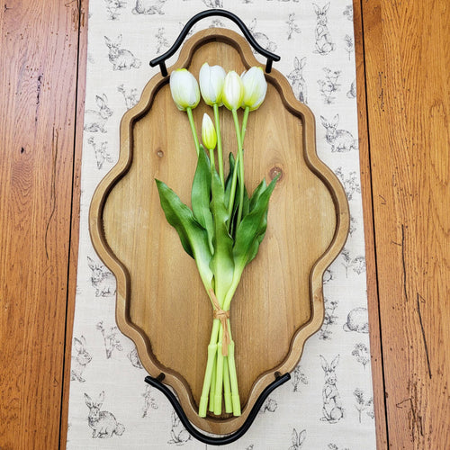 White real touch tulip bundle laying on an ornate arabesque tray.
