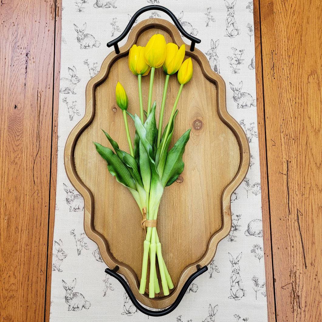 Real touch yellow tulip bundle laying on an ornate wood tray.
