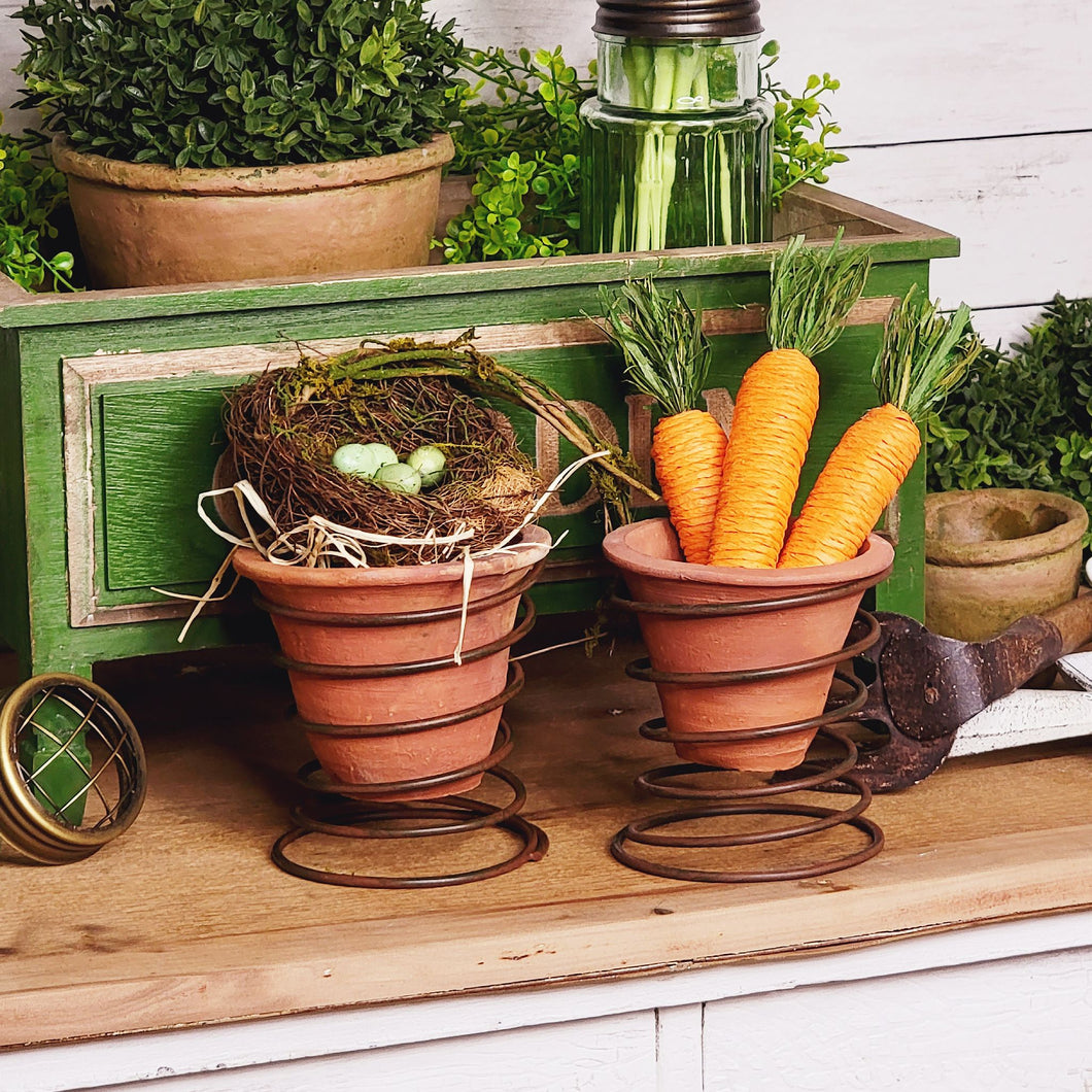 Handmade rustic terracotta garden pot set in a vintage bedspring